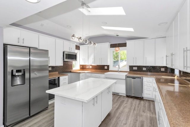 6N772 Tuscola Ave, Saint Charles, IL 60174 - kitchen with stainless steel appliances, a skylight, a sink, vaulted ceiling, and wine cooler