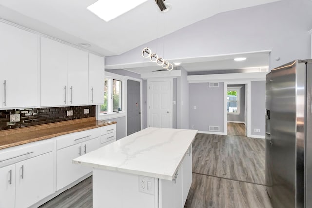 6N772 Tuscola Ave, Saint Charles, IL 60174 - kitchen with stainless steel refrigerator with ice dispenser, vaulted ceiling, decorative backsplash, a kitchen island, and wood finished floors