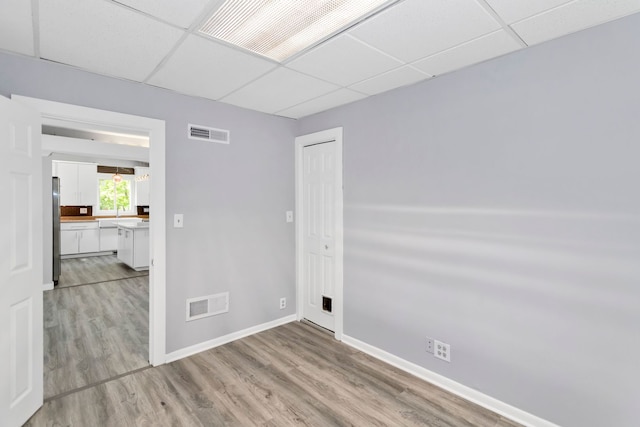 6N772 Tuscola Ave, Saint Charles, IL 60174 - spare room featuring a drop ceiling, baseboards, and light wood-type flooring