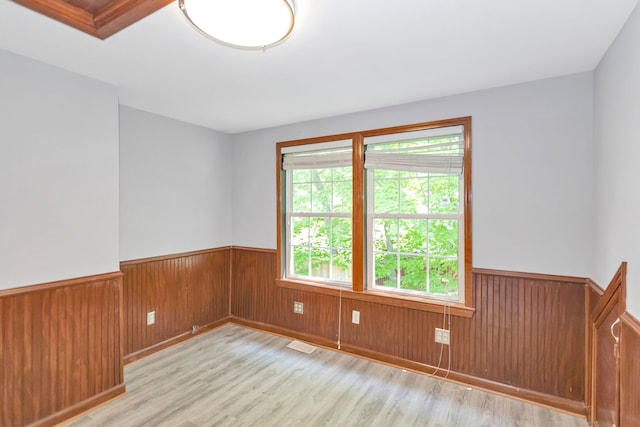 6N772 Tuscola Ave, Saint Charles, IL 60174 - spare room featuring a wainscoted wall, light wood-style floors, and wooden walls