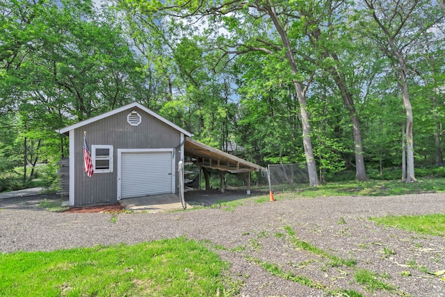 6N772 Tuscola Ave, Saint Charles, IL 60174 - garage featuring driveway, fence, and a garage