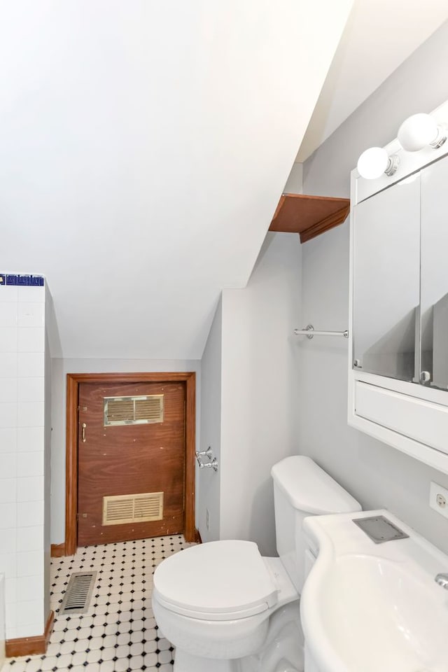 6N772 Tuscola Ave, Saint Charles, IL 60174 - bathroom with a sink, toilet, and vaulted ceiling
