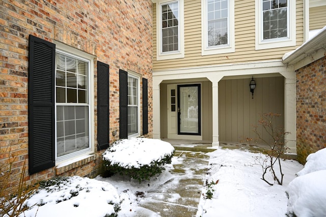 view of snow covered property entrance