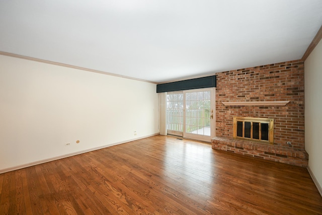 unfurnished living room with crown molding, a brick fireplace, and hardwood / wood-style flooring