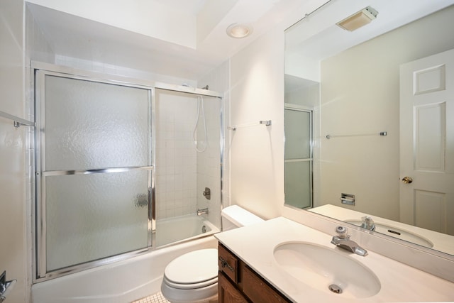 full bathroom featuring bath / shower combo with glass door, vanity, and toilet