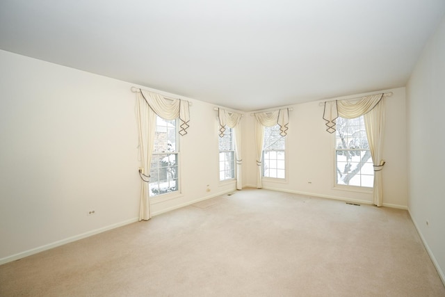 spare room with light carpet