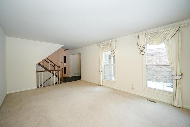 unfurnished living room featuring carpet flooring