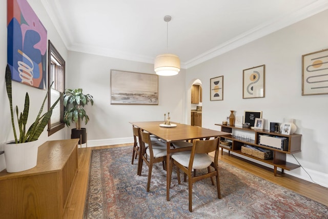 dining area featuring ornamental molding and hardwood / wood-style floors