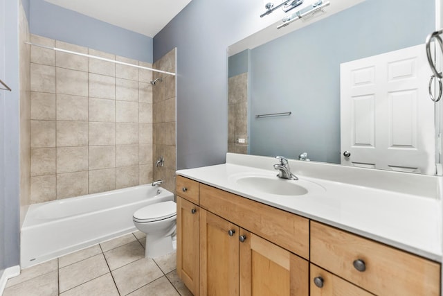 full bathroom with tile patterned flooring, vanity, tiled shower / bath combo, and toilet