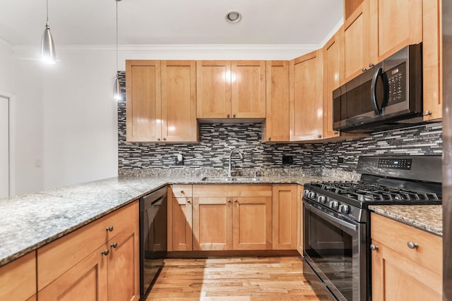 kitchen featuring light stone countertops, sink, hanging light fixtures, black appliances, and ornamental molding