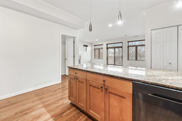 kitchen with light hardwood / wood-style floors, light stone countertops, pendant lighting, and ornamental molding