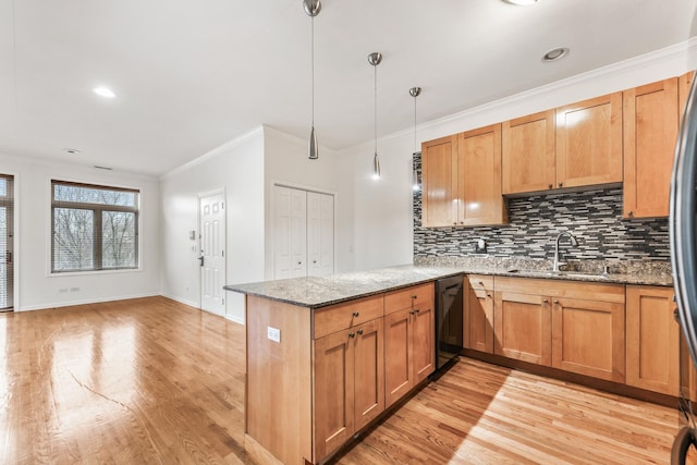 kitchen with dishwasher, stone countertops, sink, decorative light fixtures, and kitchen peninsula