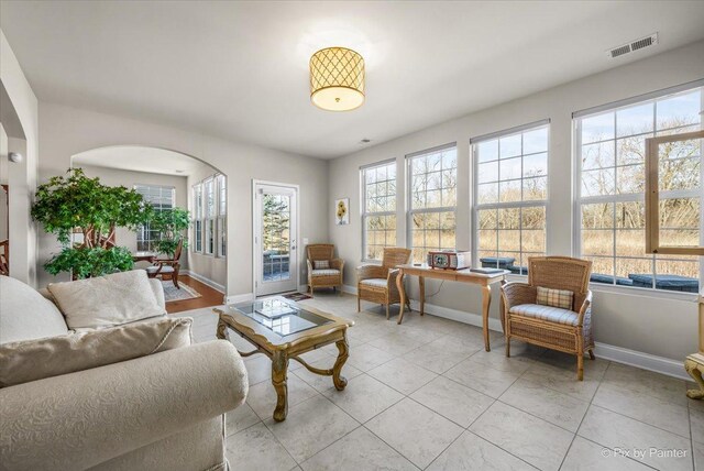 living room featuring plenty of natural light and light tile patterned floors