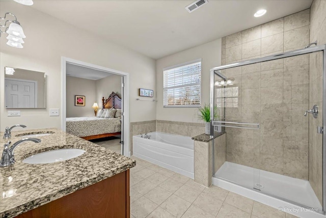 bathroom with tile patterned flooring, vanity, and shower with separate bathtub