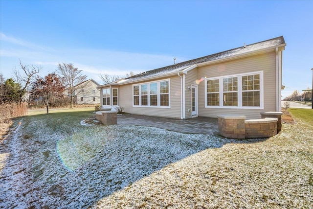 rear view of house featuring a patio area and a yard