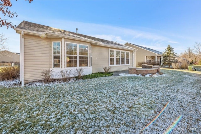 rear view of property featuring a patio area and a lawn