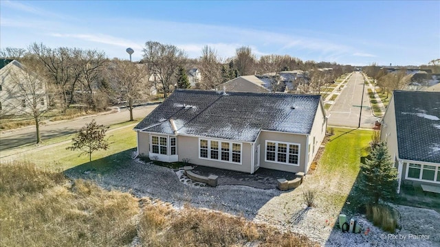 back of house featuring a lawn