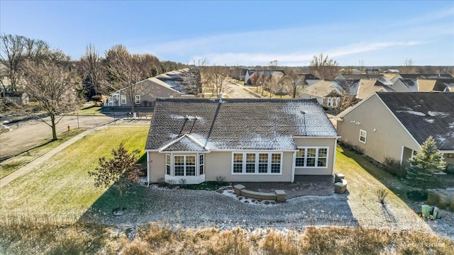 rear view of house with a lawn