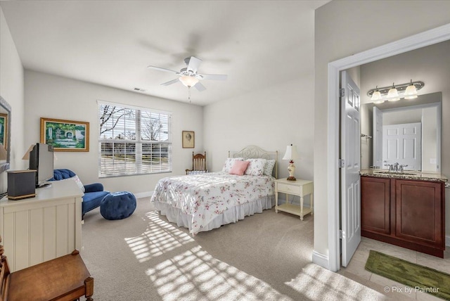 carpeted bedroom with ceiling fan and sink