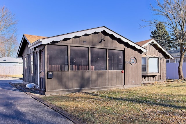 view of side of home with a lawn