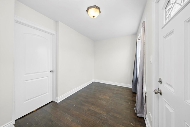 interior space featuring dark wood finished floors and baseboards