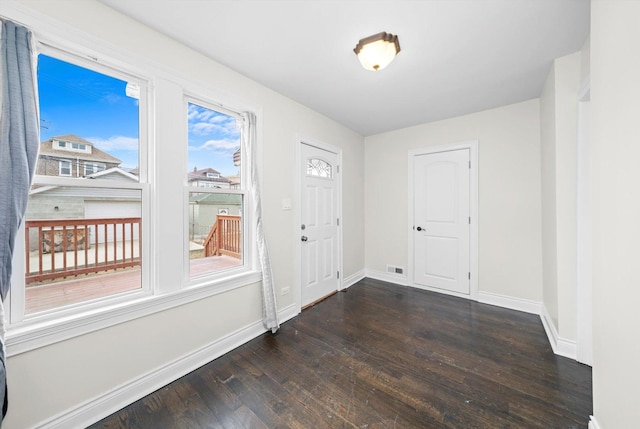 interior space with visible vents, baseboards, and wood finished floors