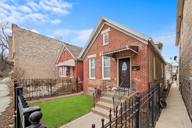 view of front of home with fence, a front lawn, and brick siding