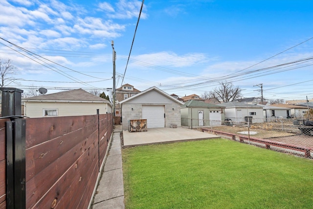 exterior space with a garage, driveway, an outdoor structure, and a fenced backyard