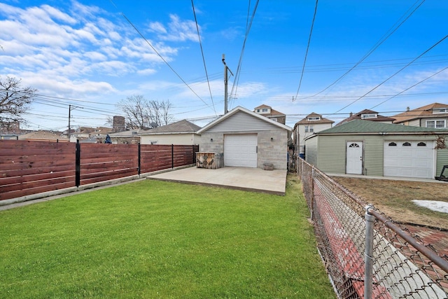 view of yard featuring a patio area, an outdoor structure, a fenced backyard, and a detached garage