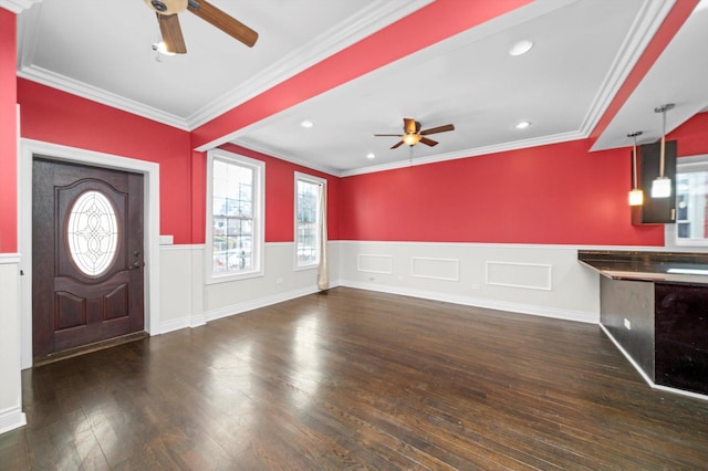 entryway with ceiling fan, ornamental molding, wainscoting, and wood finished floors