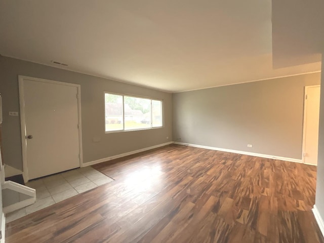 unfurnished room with wood-type flooring