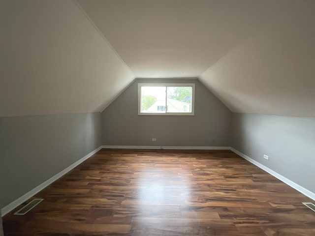 bonus room with dark hardwood / wood-style floors and lofted ceiling