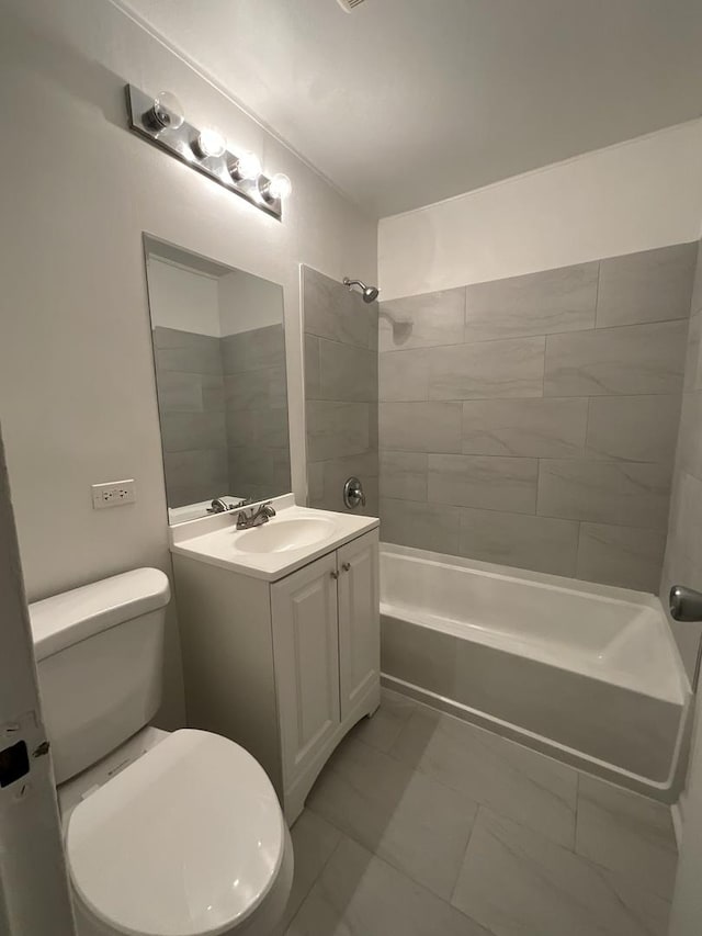 full bathroom with vanity, tiled shower / bath combo, and toilet