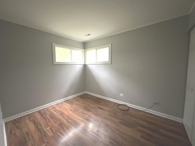 spare room with dark wood-type flooring