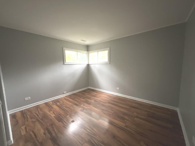 unfurnished room with dark wood-type flooring