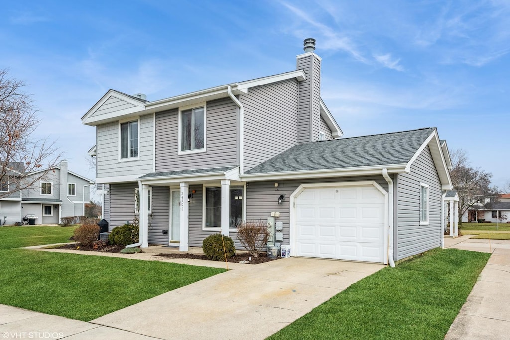 view of front of home featuring a front yard and a garage