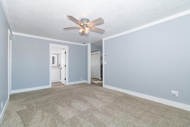 unfurnished room with carpet, ceiling fan, and crown molding