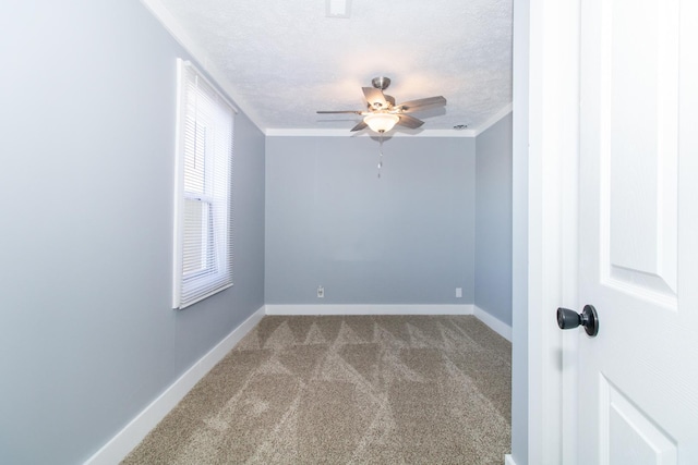 spare room with light carpet, crown molding, a textured ceiling, and ceiling fan