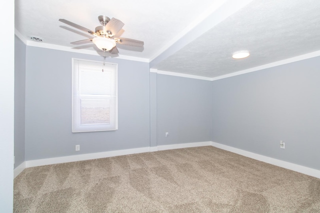 carpeted empty room with ceiling fan and crown molding