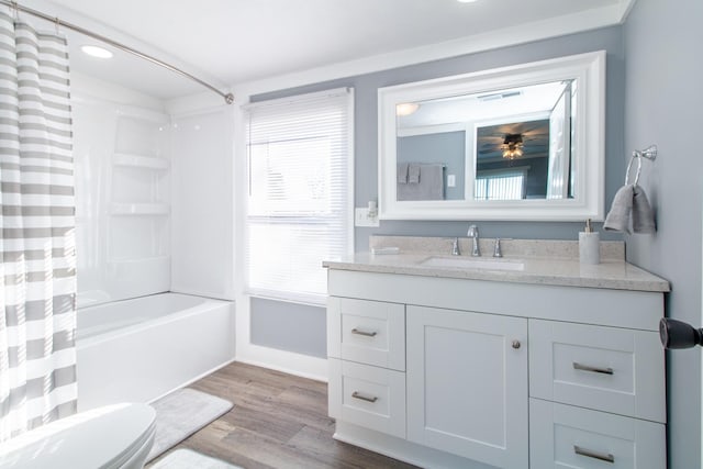 full bathroom with toilet, shower / bath combination with curtain, hardwood / wood-style floors, and vanity