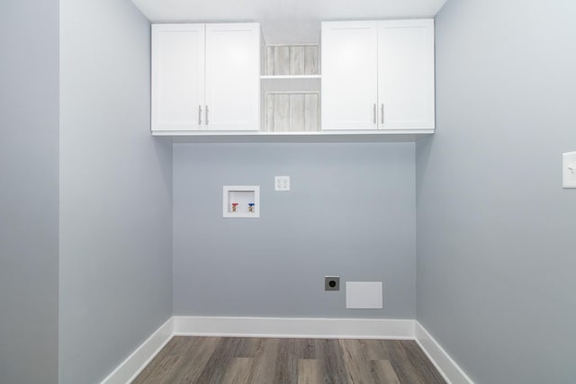 washroom featuring washer hookup, dark wood-type flooring, hookup for an electric dryer, and cabinets