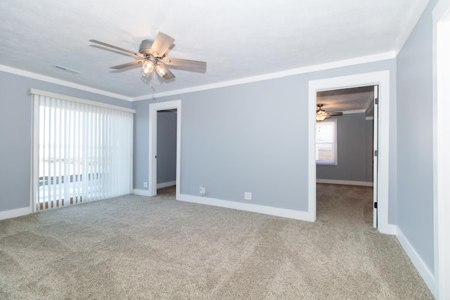 carpeted empty room with ceiling fan and ornamental molding