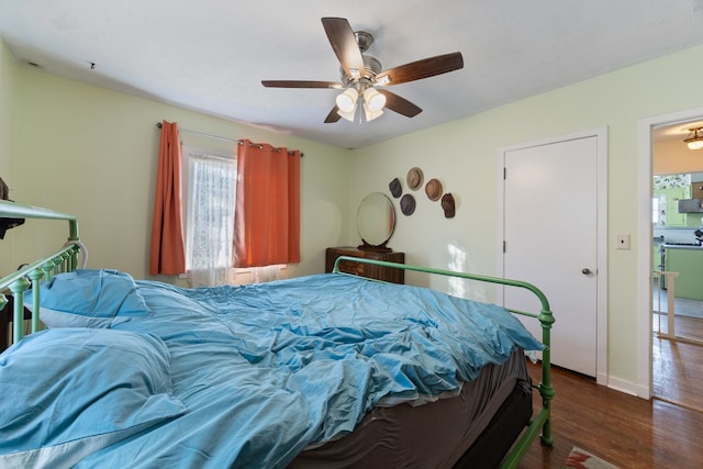 bedroom featuring ceiling fan and dark hardwood / wood-style flooring