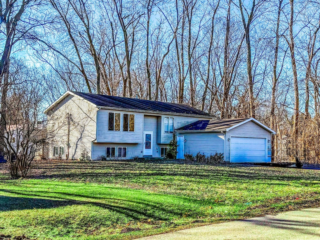 split foyer home with a front lawn and a garage