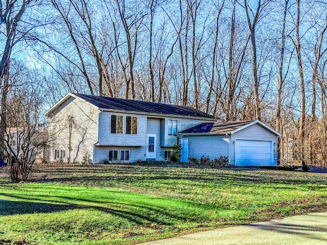 split foyer home with a front lawn and a garage