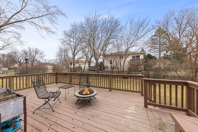 deck featuring a yard and an outdoor fire pit