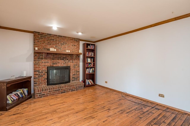 unfurnished living room featuring crown molding, light hardwood / wood-style floors, and a brick fireplace