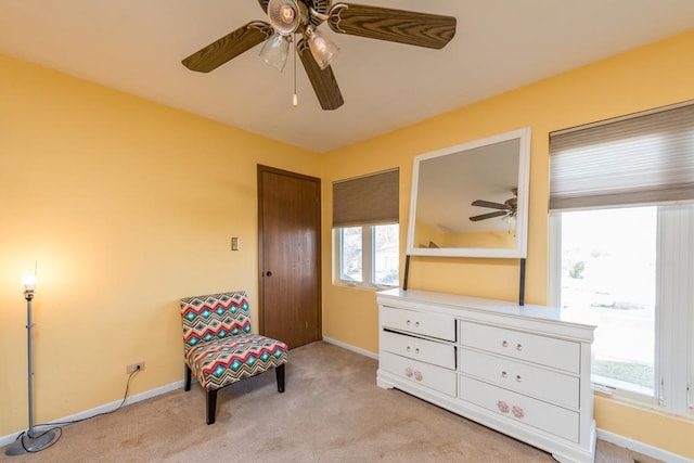 sitting room featuring light colored carpet