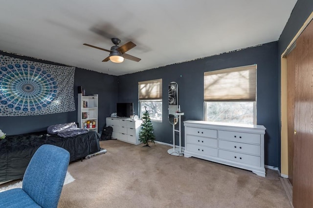 bedroom featuring ceiling fan, a closet, and light carpet