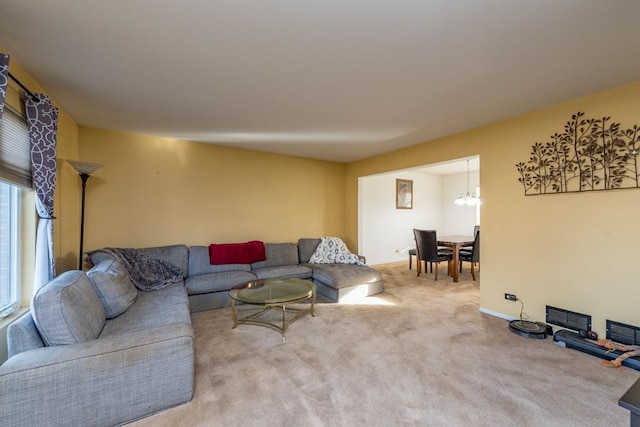 living room featuring carpet and a chandelier